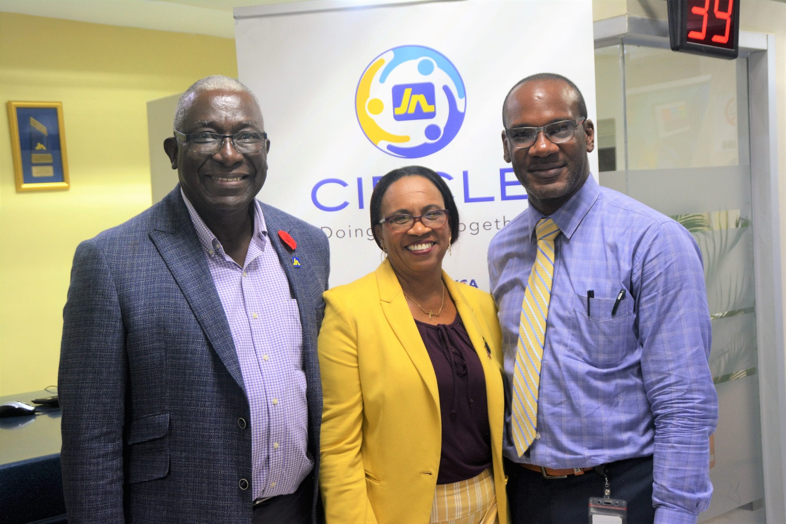 Reverend Dr Carla Dunbar (centre) takes a group photo with Major Effiom Whyte (left), member relations coordinator and Edison Taylor, business relationship and sales manager at JN Bank Port Antonio at the JN Circle Meeting, recently.