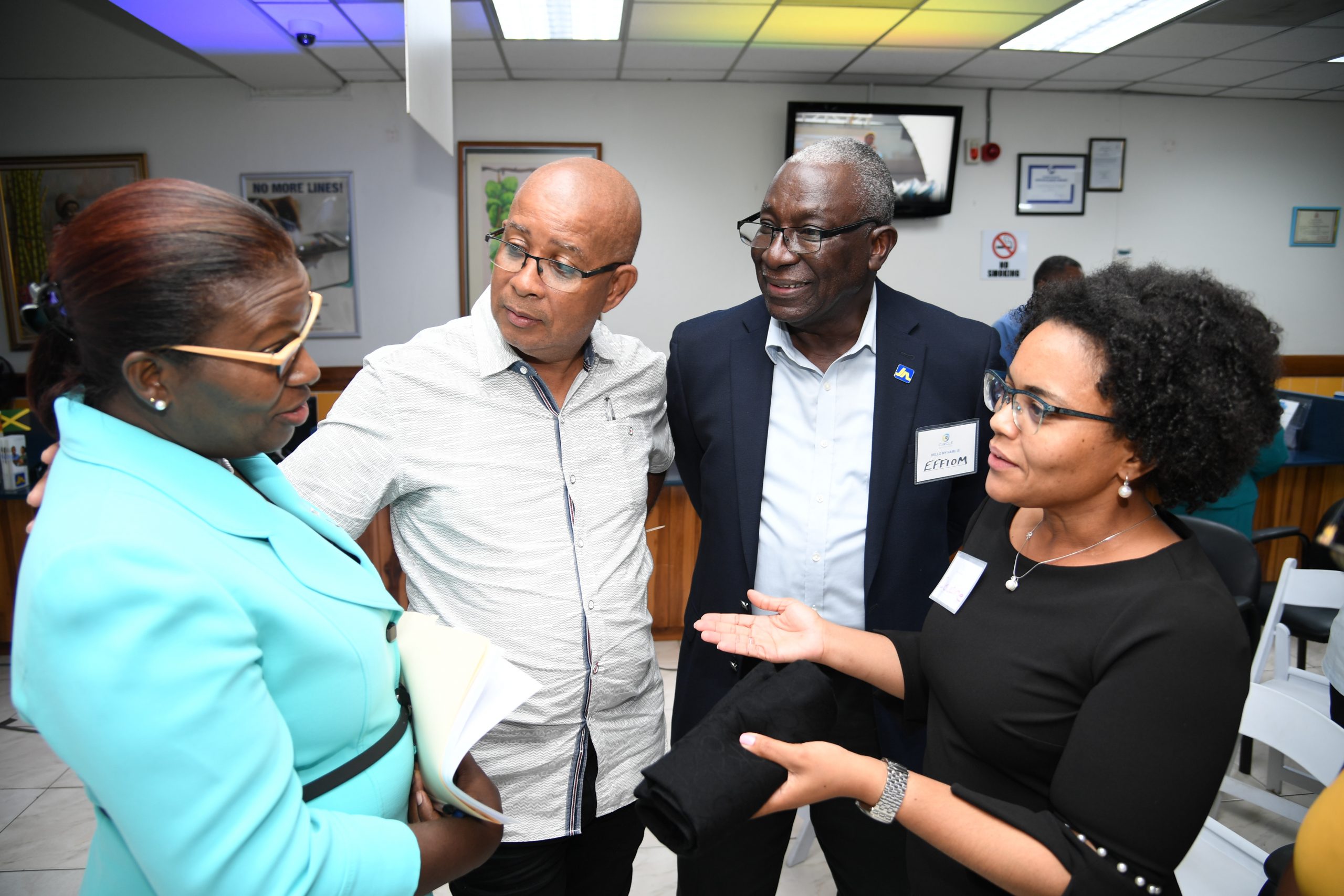Claudine Allen (right), member ombudsman, at The Jamaica National Group makes a point to Michelle Hines (left), Business Relationship and Sales Manager at JN Bank at the inaugural meeting of the JN Circle, Spanish Town. Looking on are Councillor Norman Scott (second left), Mayor of Spanish Town and Major Effiom Whyte, member relations coordinator with JN Group.