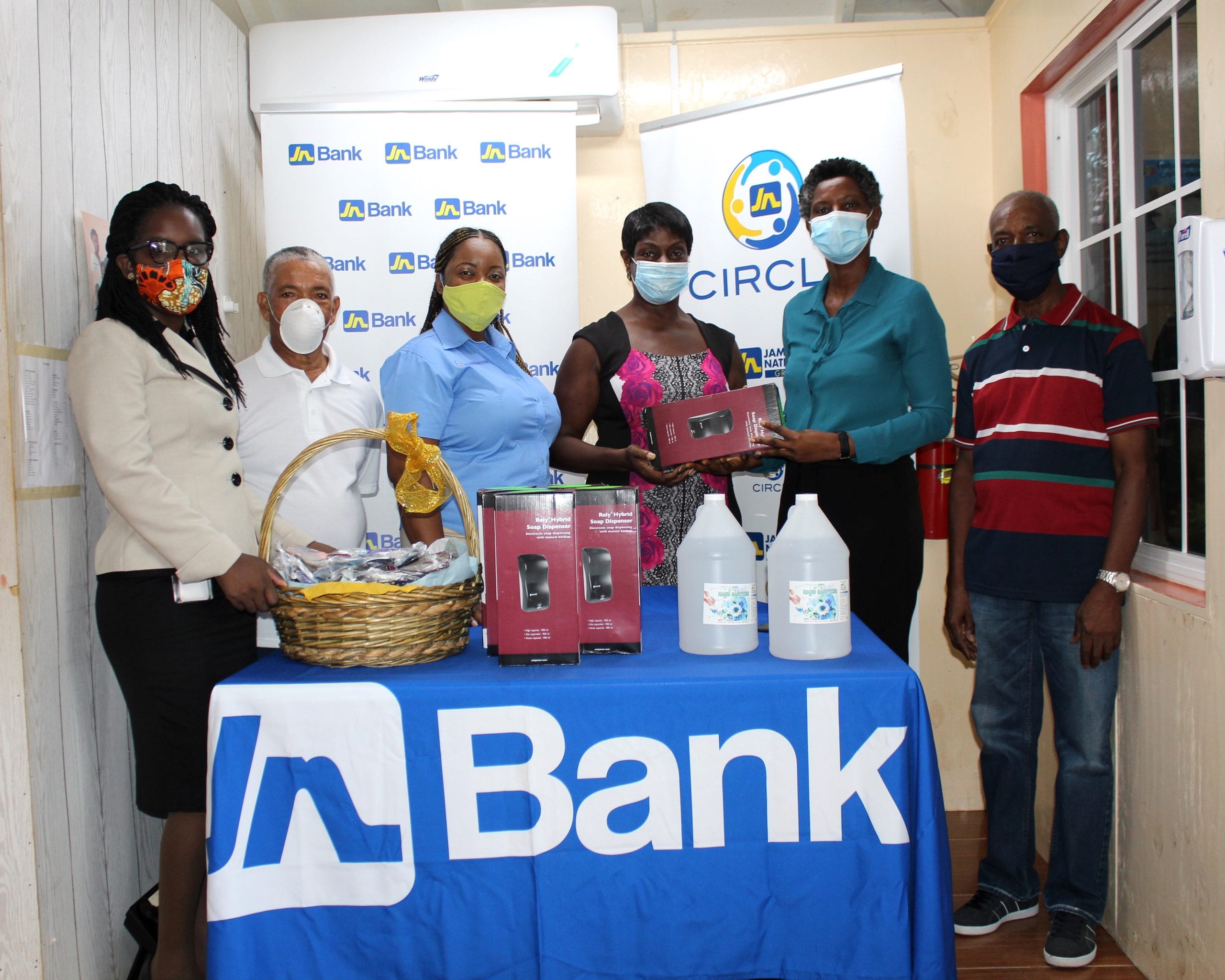 Six automatic sanitizer dispensers, sanitizer gel and 200 cloth masks were recently donated to the Black River Hospital by JN Circle Santa Cruz. Hyacinth Greaves, President Kervis Greaves, Circle member and Lorna Sinclair, Business Relationship and Sales Manager were present.