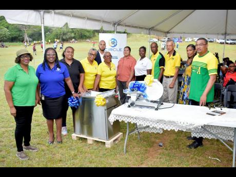 The JN Foundation presented the Cross Keys Development Area Committee (DAC) with a deep fryer and commercial slicer for its agro-processing facility and a pavilion stand in Cross Keys, Manchester. On hand to make the presentation to members of the Cross Keys DAC are Alethia Peart (second left), business relationship and sales manager at JN Bank; and Dawnette Pryce-Thompson (fifth right), project coordinator, JN Foundation.