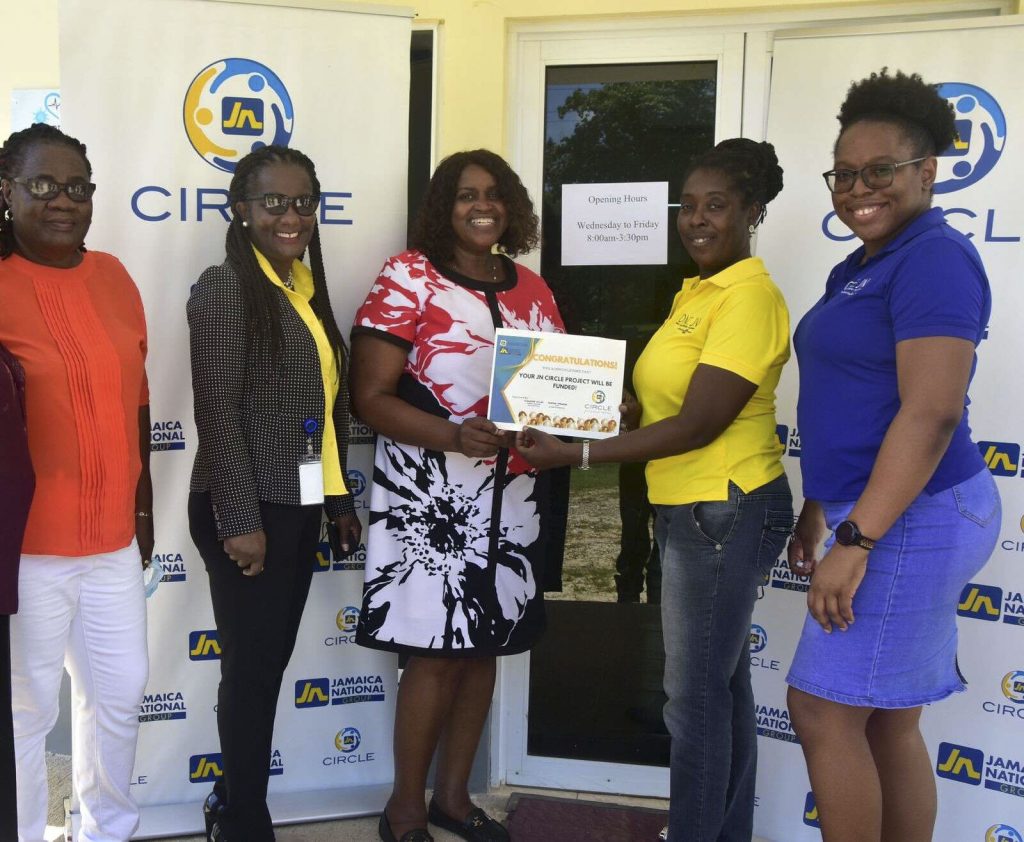 Dawnette Pryce-Thompson (second right), project coordinator at the JN Foundation presents Donna Burton (third right), centre manager at the Women’s Centre of Jamaica Foundation with a funding approval to outfit the new centre with furniture. Sharing in the moment are: Marva Edwards (left), JN Circle member; Lorna Sinclair (second left) , business relationship and sales manager for St Elizabeth, JN Bank and Celia Burnett (right), member relations coordinator, The Jamaica National Group.
